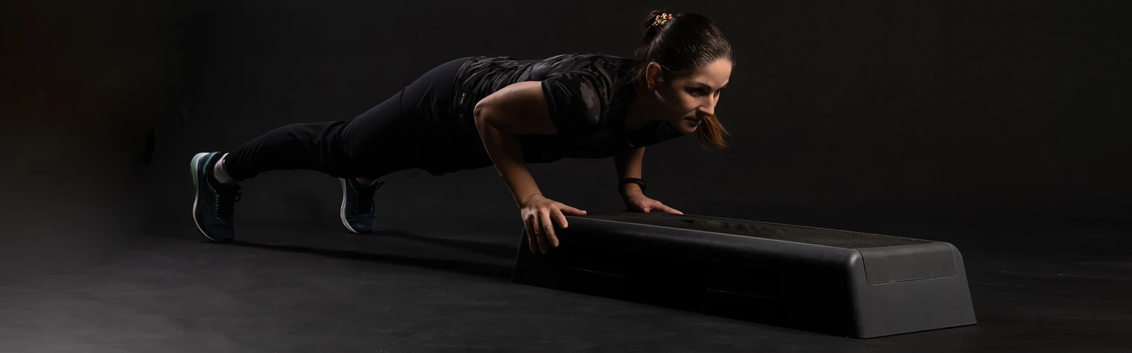 Women doing push-ups on stepper